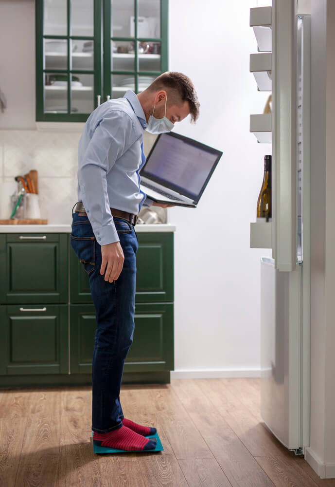 man in front of fridge